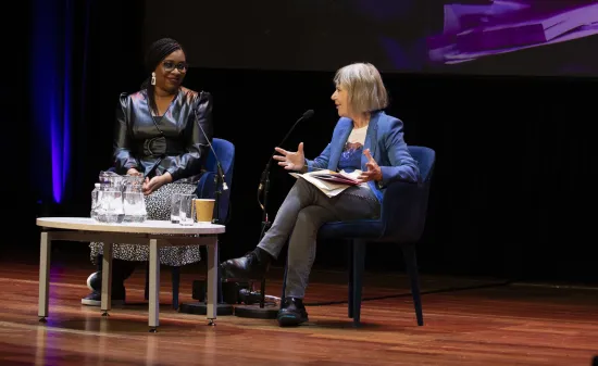 Two women on stage talking