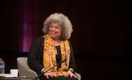 Angela Davis on a stage smiling